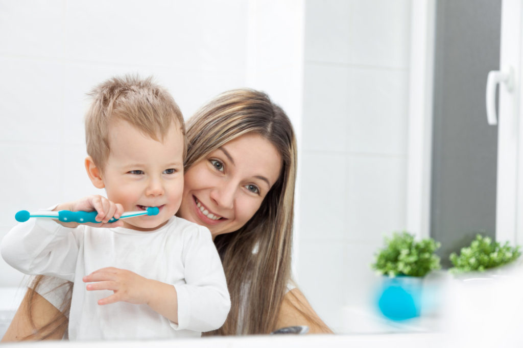 Mom Teaching Kid How To Brush Teeth